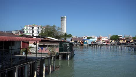 Panning-Penang-heritage-clan-house-at-sea-with-background-KOMTAR
